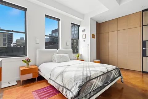a bedroom with bed and window