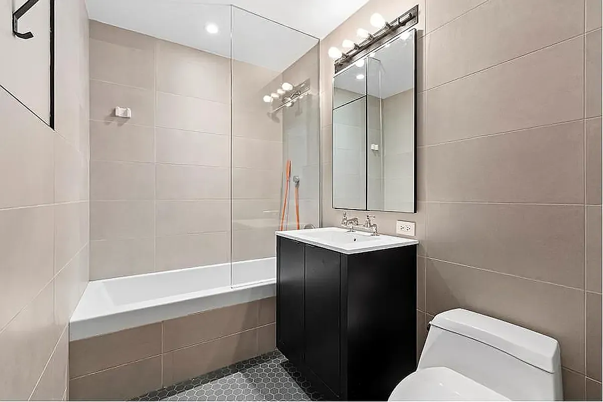 540 West 28th Street, Unit 8A Manhattan, NY 10001 - Photo 4 of 12 a bathroom with a sink toilet and shower