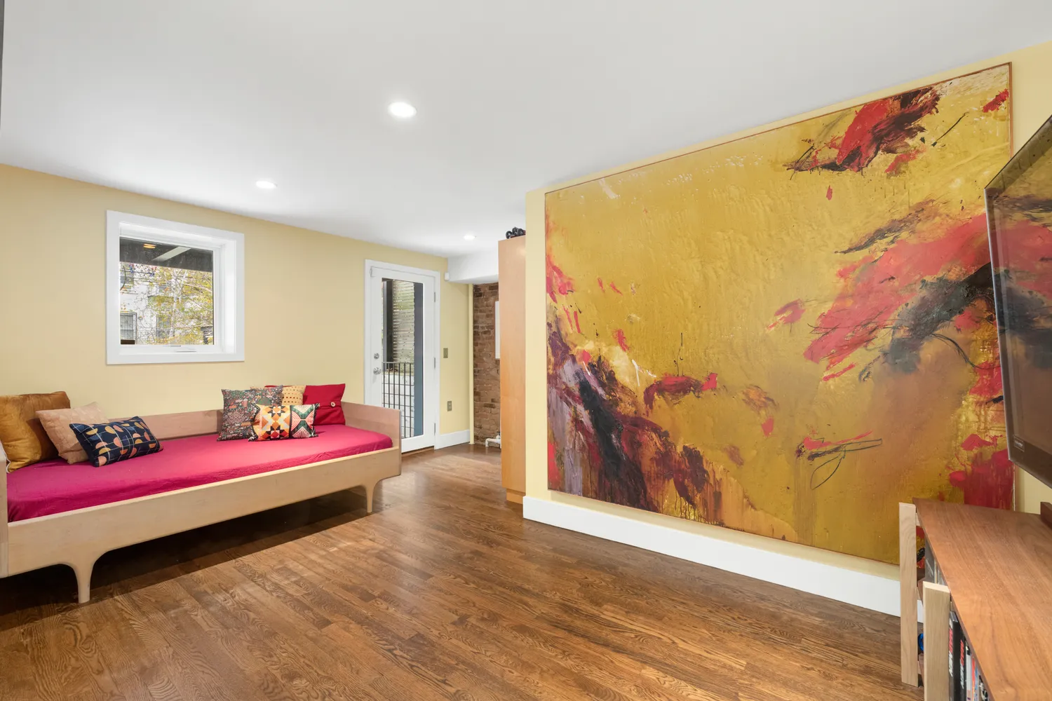 a bedroom with a bed and wooden floor