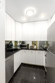 a kitchen with stainless steel appliances a sink a stove a microwave and cabinets