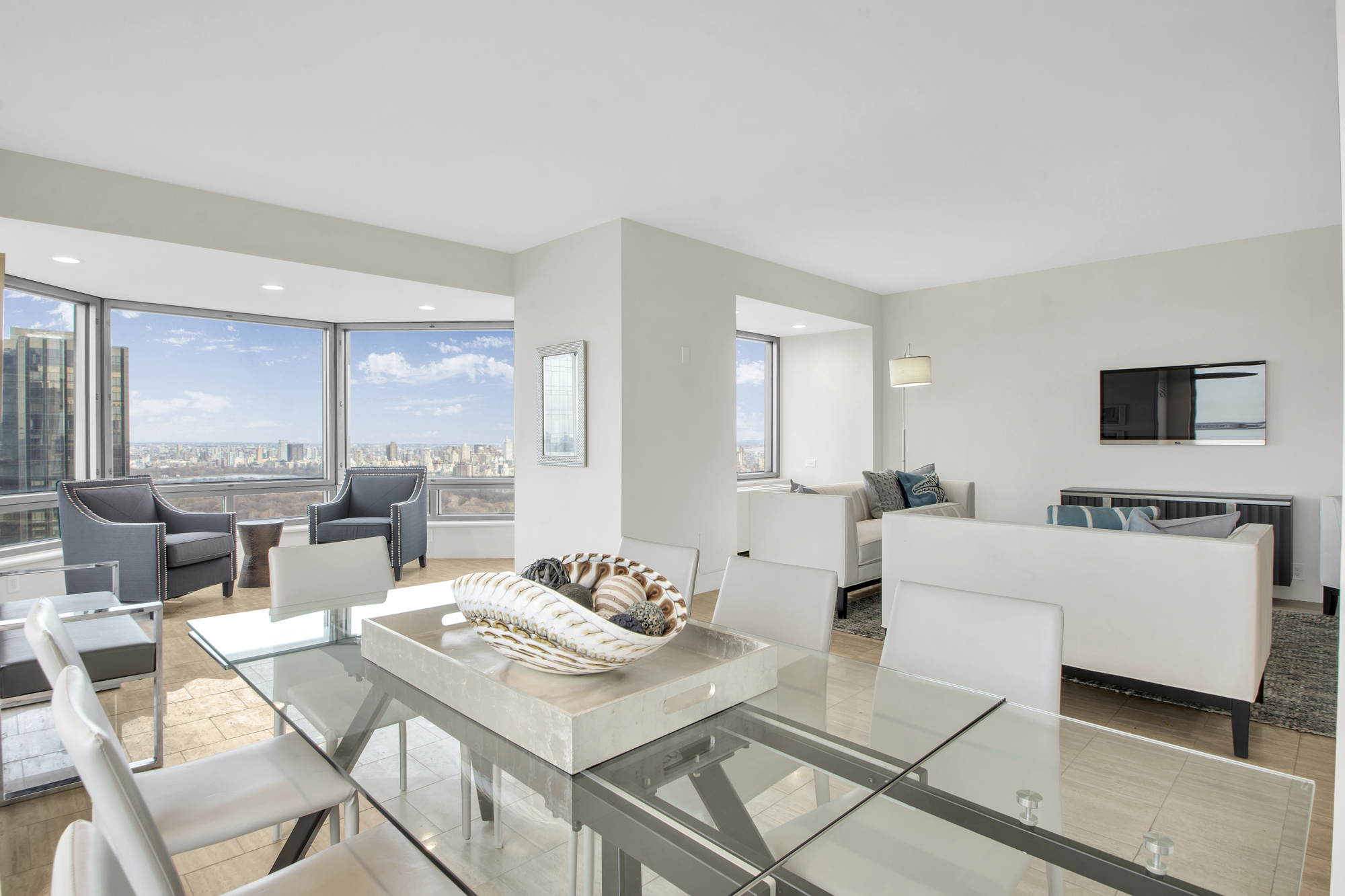 301 West 57th Street, Unit 48A Manhattan, NY 10019 - Photo 20 of 22 a living room with furniture and a flat screen tv