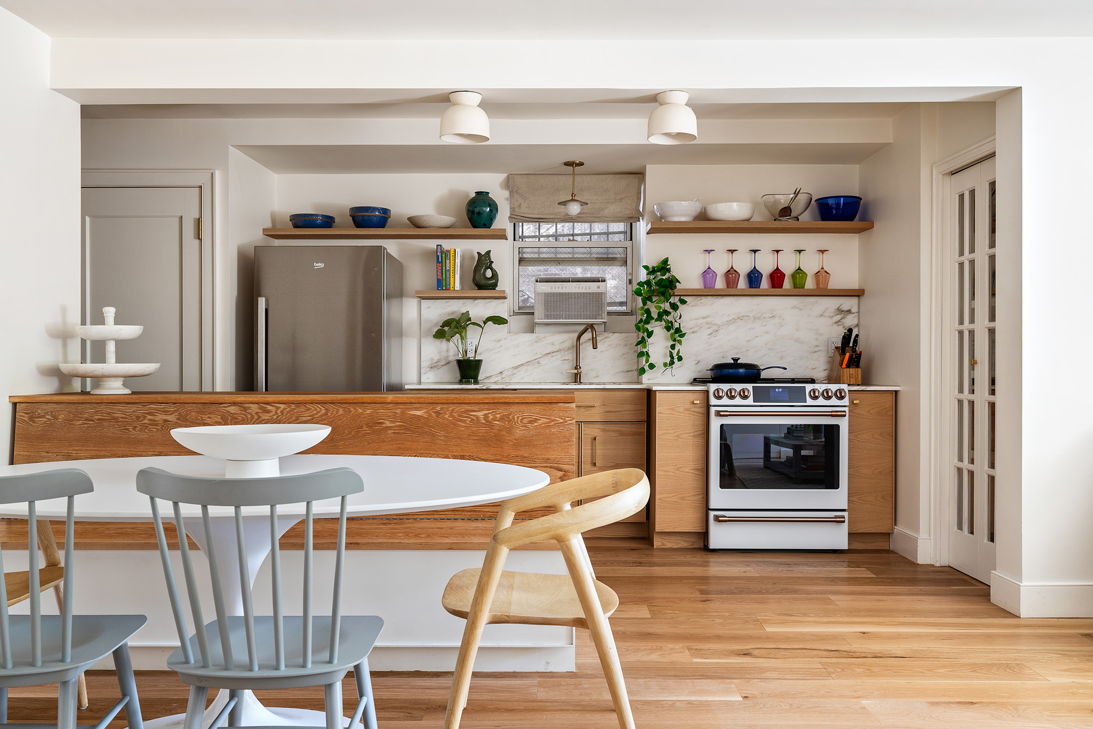 417 Clinton Street, Unit 1 Brooklyn, NY 11231 - Photo 2 of 18 a kitchen with stainless steel appliances kitchen island granite countertop a table chairs in it and wooden floors