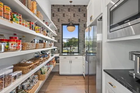a kitchen with stainless steel appliances granite countertop a large stove a sink and a refrigerator