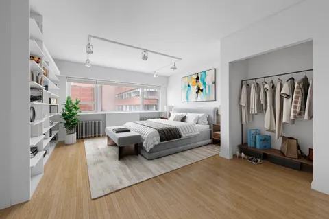 a bedroom with furniture and a wooden floor