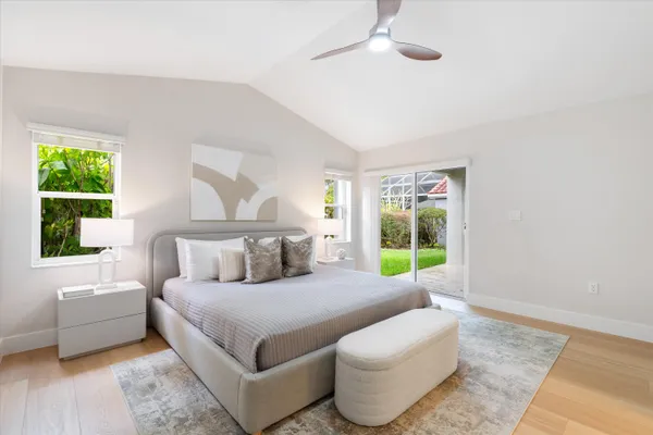 a bedroom with a bed a couch and a flat screen tv