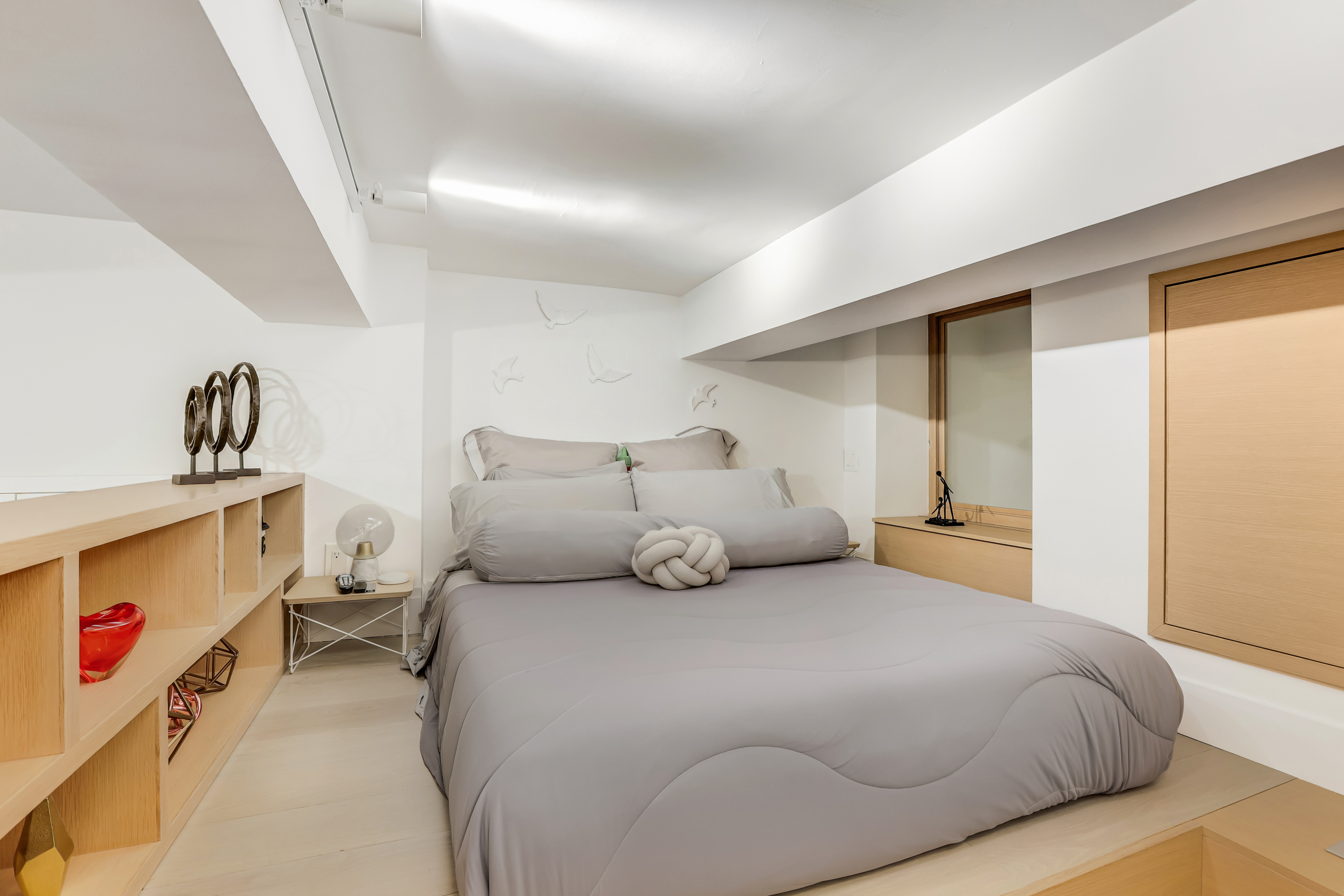 310 East 46th Street, Unit 10S Manhattan, NY 10017 - Photo 9 of 10 a bedroom with a bed and white cabinets