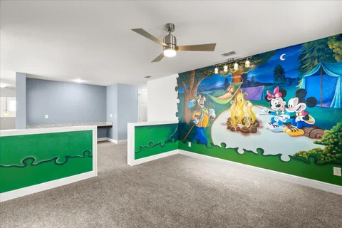 a living room with furniture and a floor to ceiling window