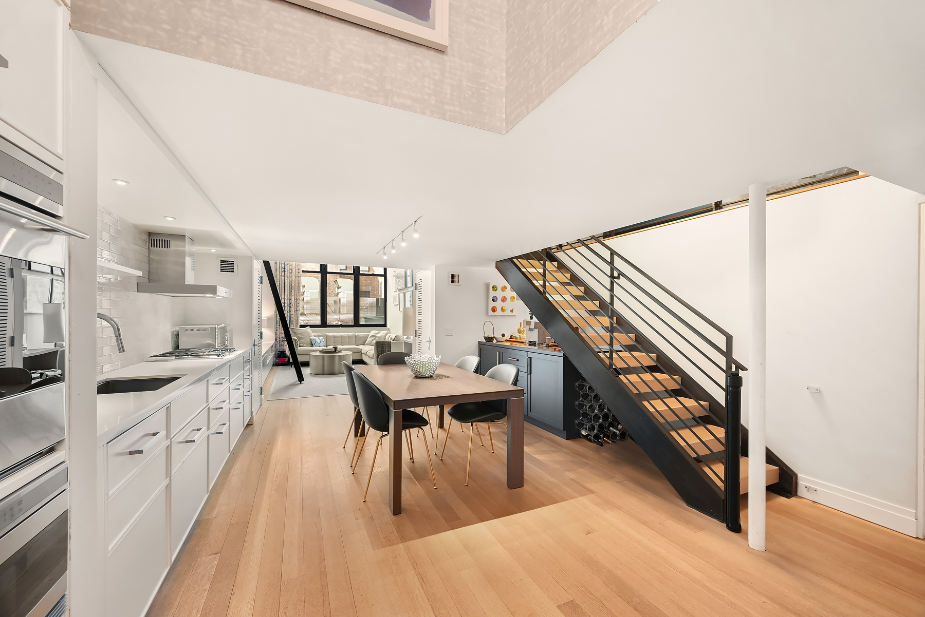 421 Hudson Street, Unit 318 Manhattan, NY 10014 - Photo 3 of 12 a dining room with furniture and wooden floor