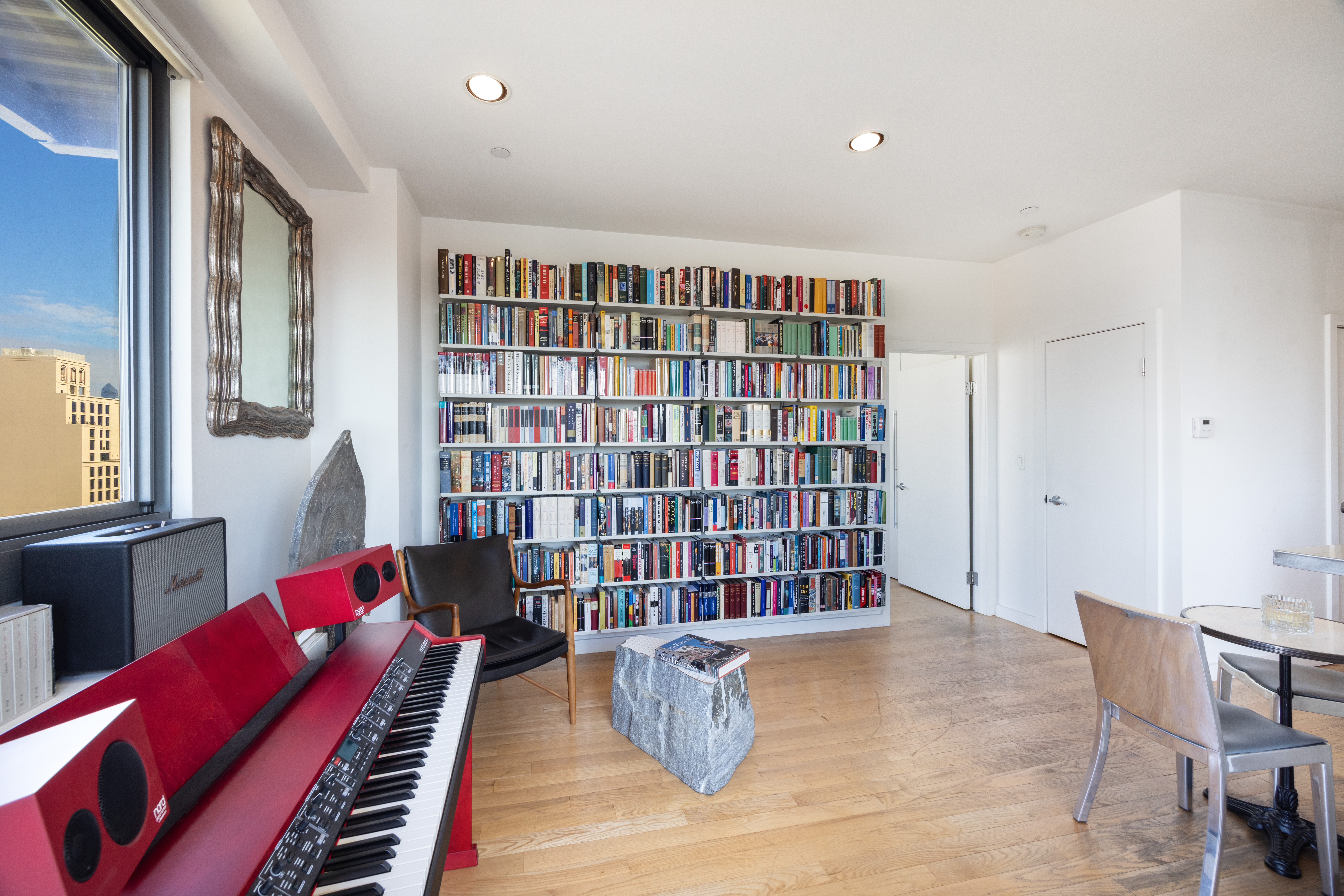 38 Delancey Street Manhattan, NY 10002 - Photo 2 of 11 a living room with furniture and book shelf