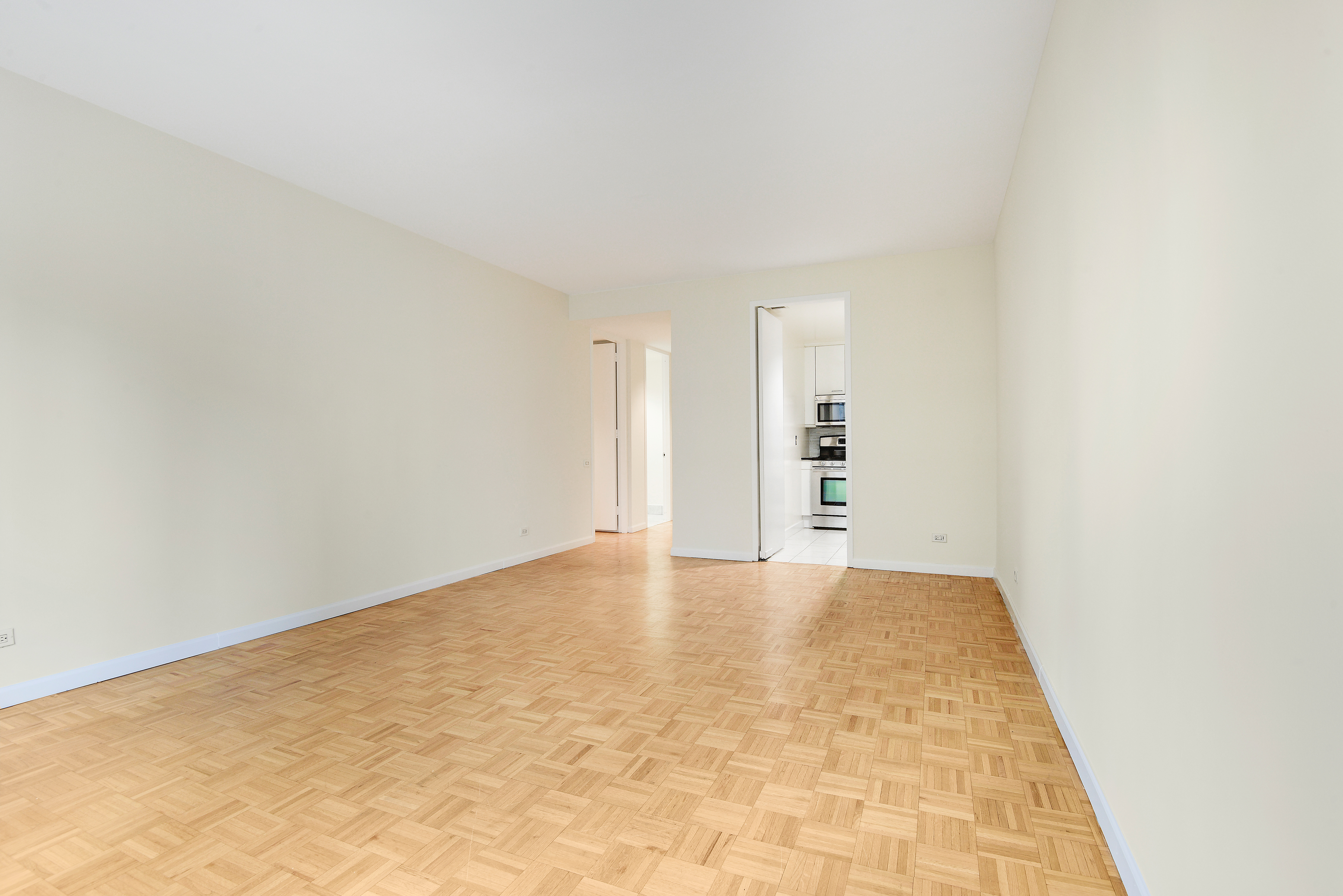 146 West 57th Street, Unit 38E Manhattan, NY 10019 - Photo 14 of 16 a view of empty room with wooden floor