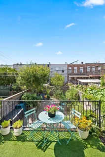 a view of a chairs and table in a patio with swimming pool
