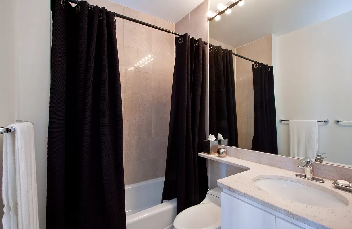 222 Riverside Drive, Unit PH2E Manhattan, NY 10025 - Photo 8 of 18 a bathroom with a sink and a mirror