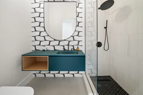 a bathroom with a toilet and a mirror