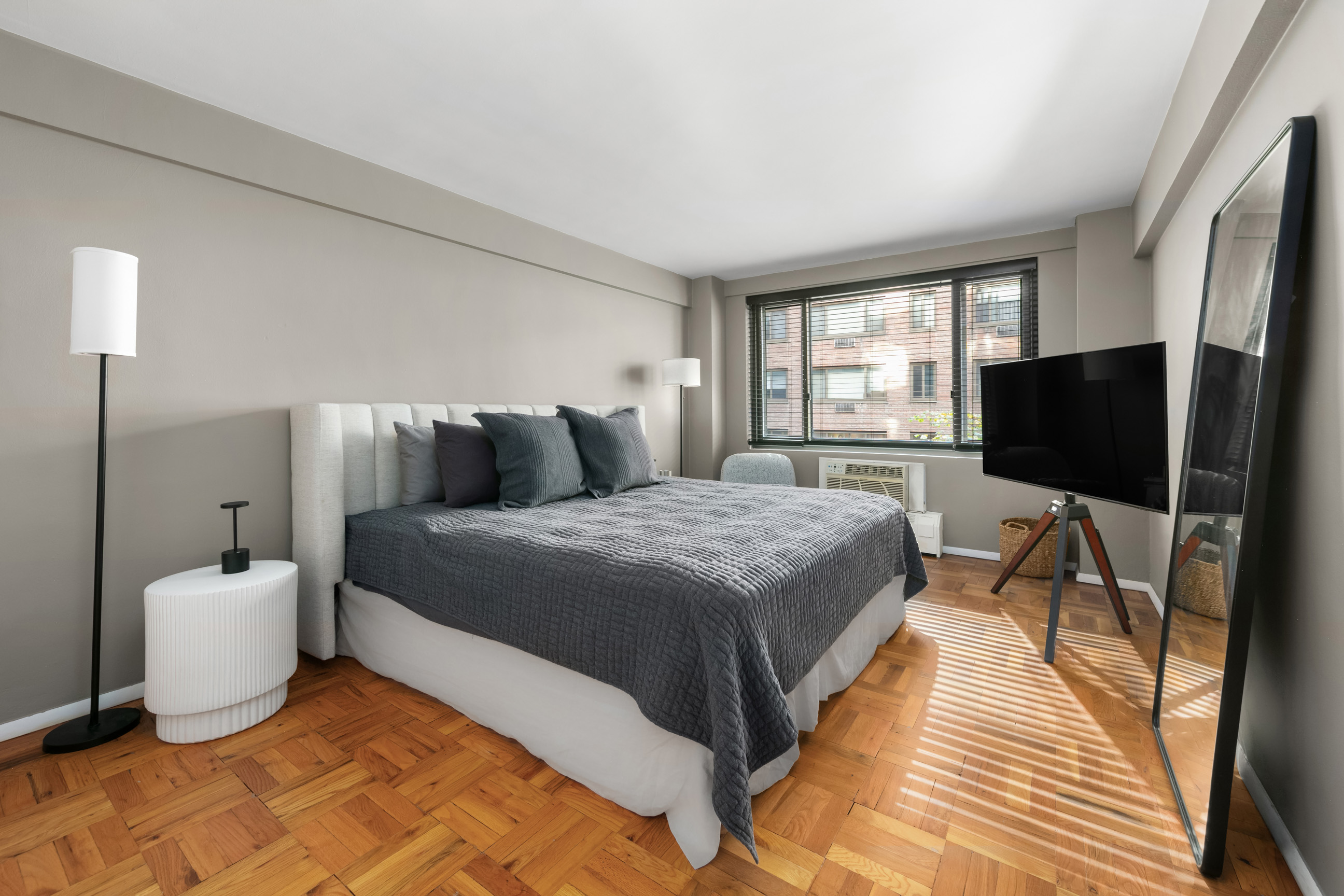 420 East 64th Street, Unit E3A Manhattan, NY 10065 - Photo 3 of 8 a bedroom with a bed and a flat screen tv