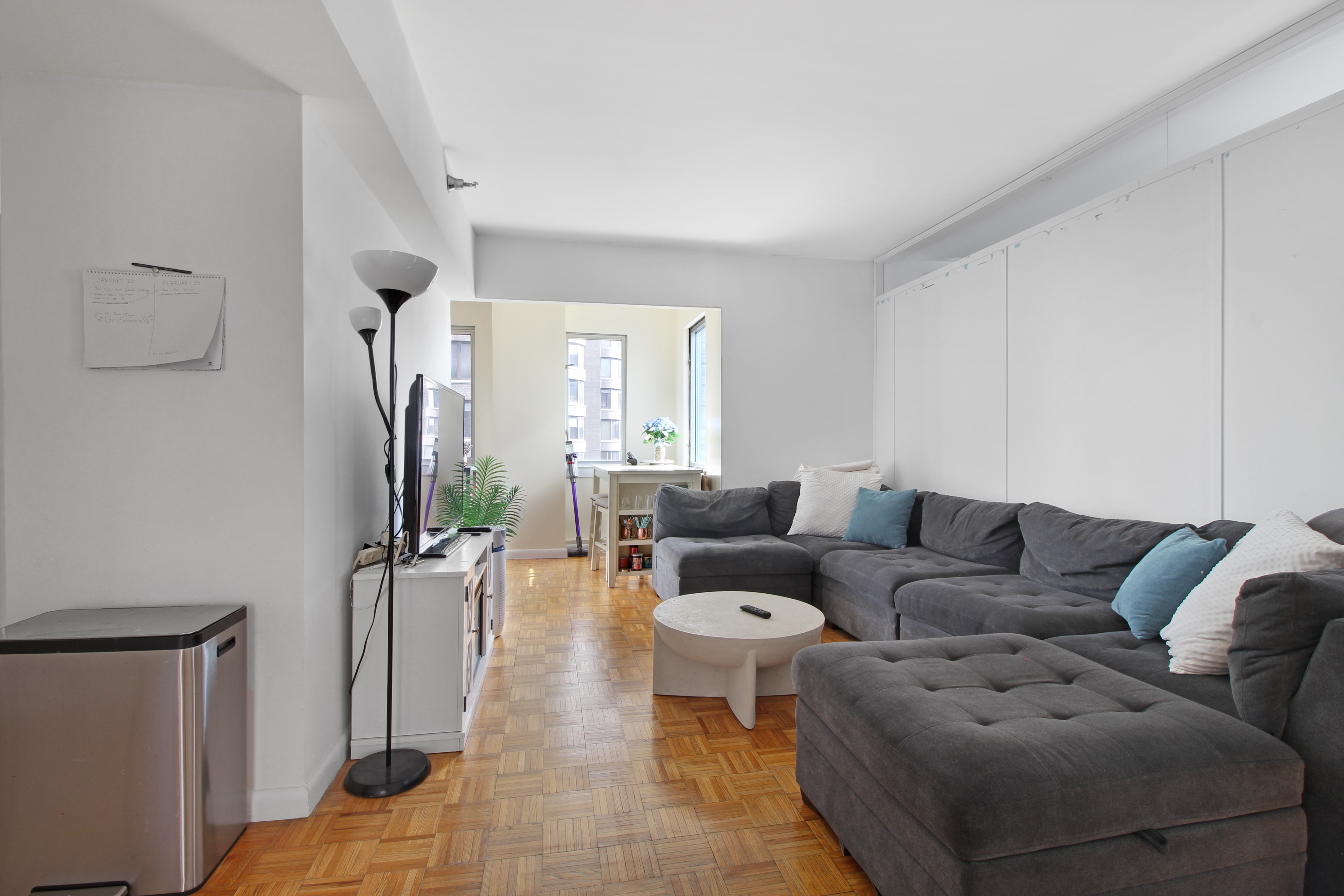 308 East 38th Street, Unit 20A Manhattan, NY 10016 - Photo 1 of 13 a living room with furniture and a flat screen tv