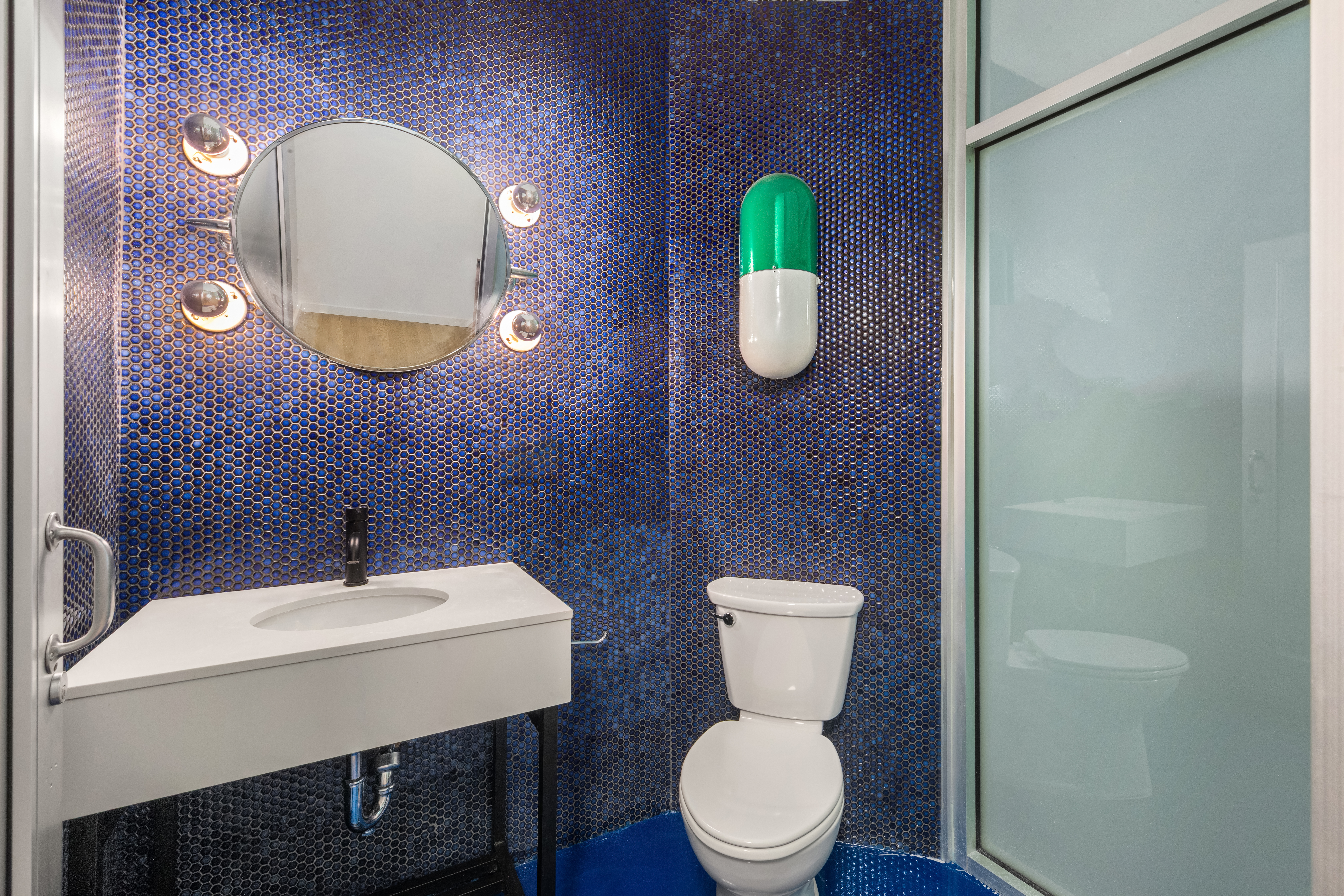 253 West 28th Street, Unit 5 Manhattan, NY 10001 - Photo 9 of 19 a bathroom with a toilet sink and mirror