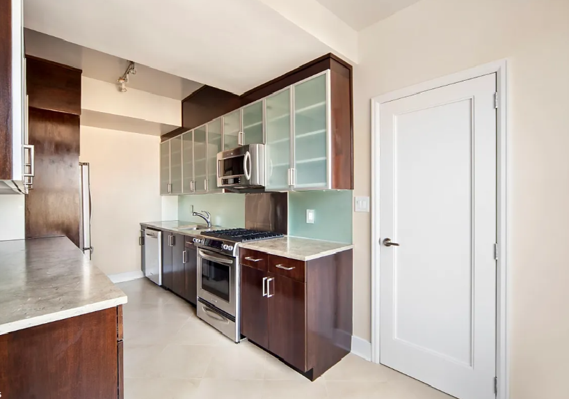 a kitchen with stainless steel appliances granite countertop a stove and a refrigerator