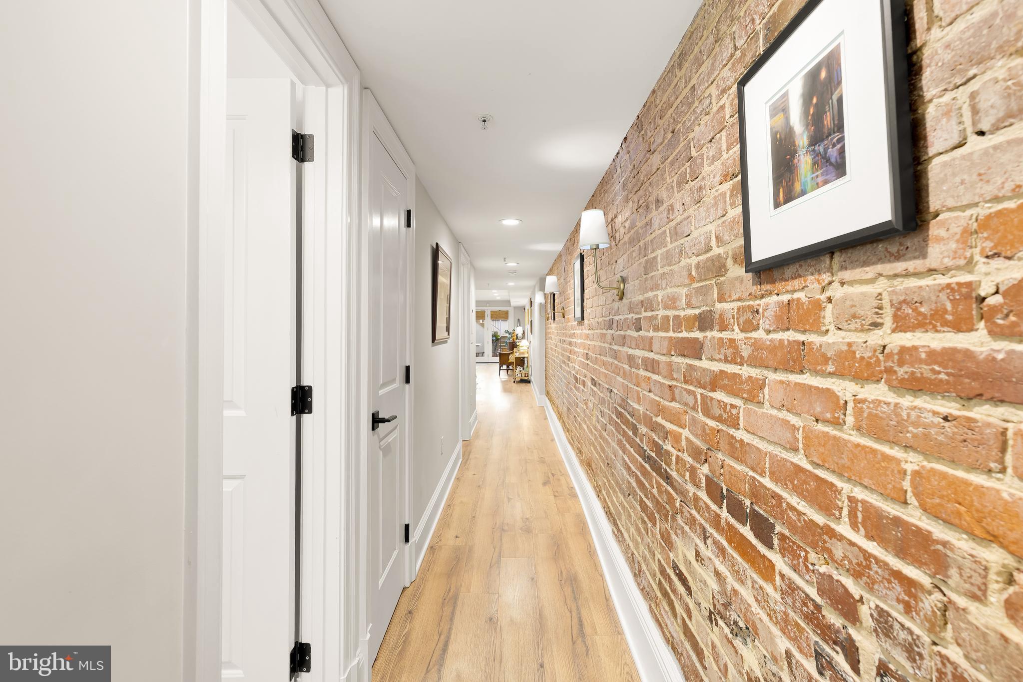 1354 Kenyon Street Northwest, Unit G Washington, DC 20010 - Photo 27 of 37 a view of a hallway with wooden floor and a bathroom