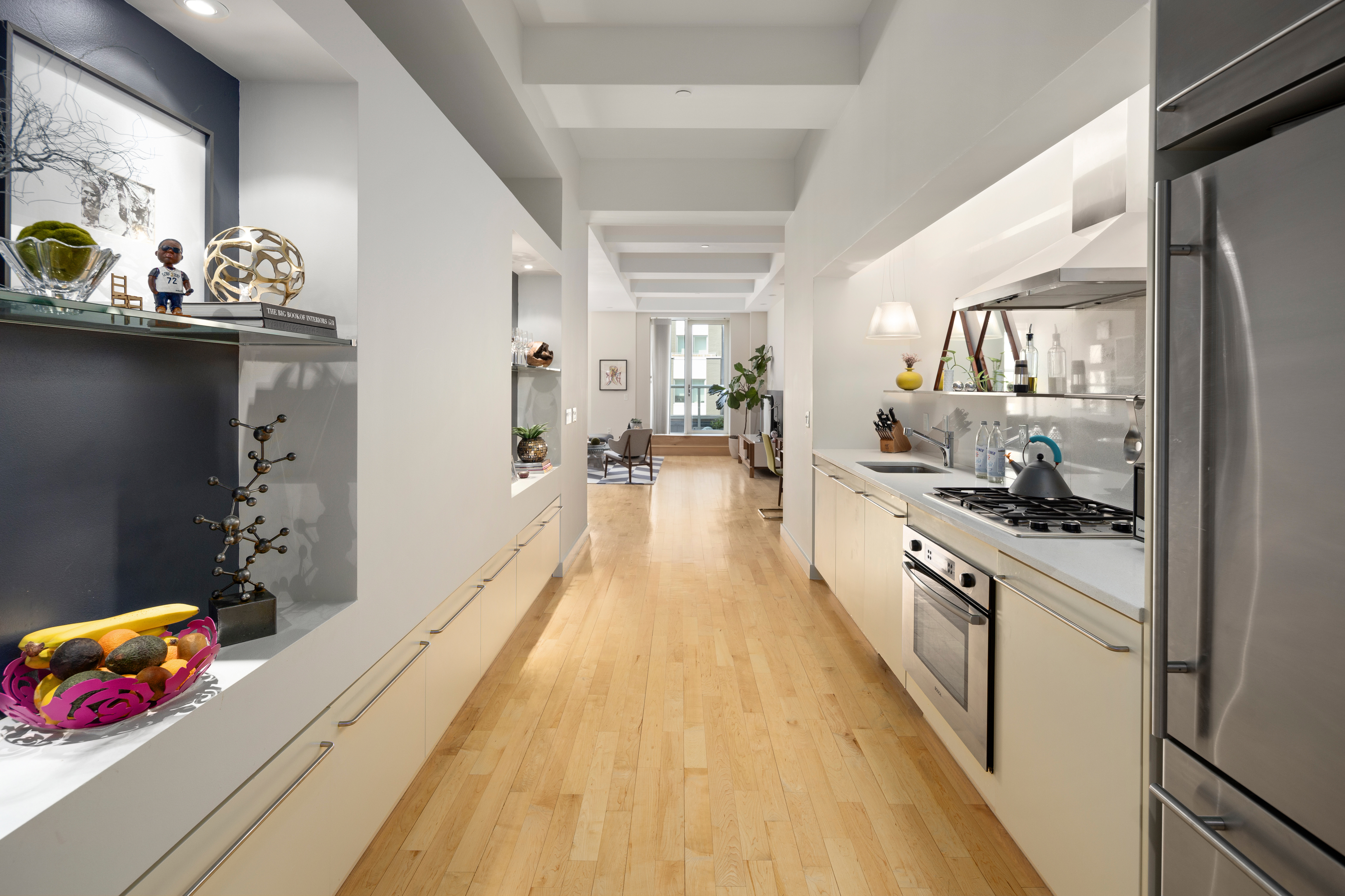 15 Broad Street, Unit 2416 Manhattan, NY 10005 - Photo 5 of 25 a large kitchen with stainless steel appliances lots of counter space and wooden floor