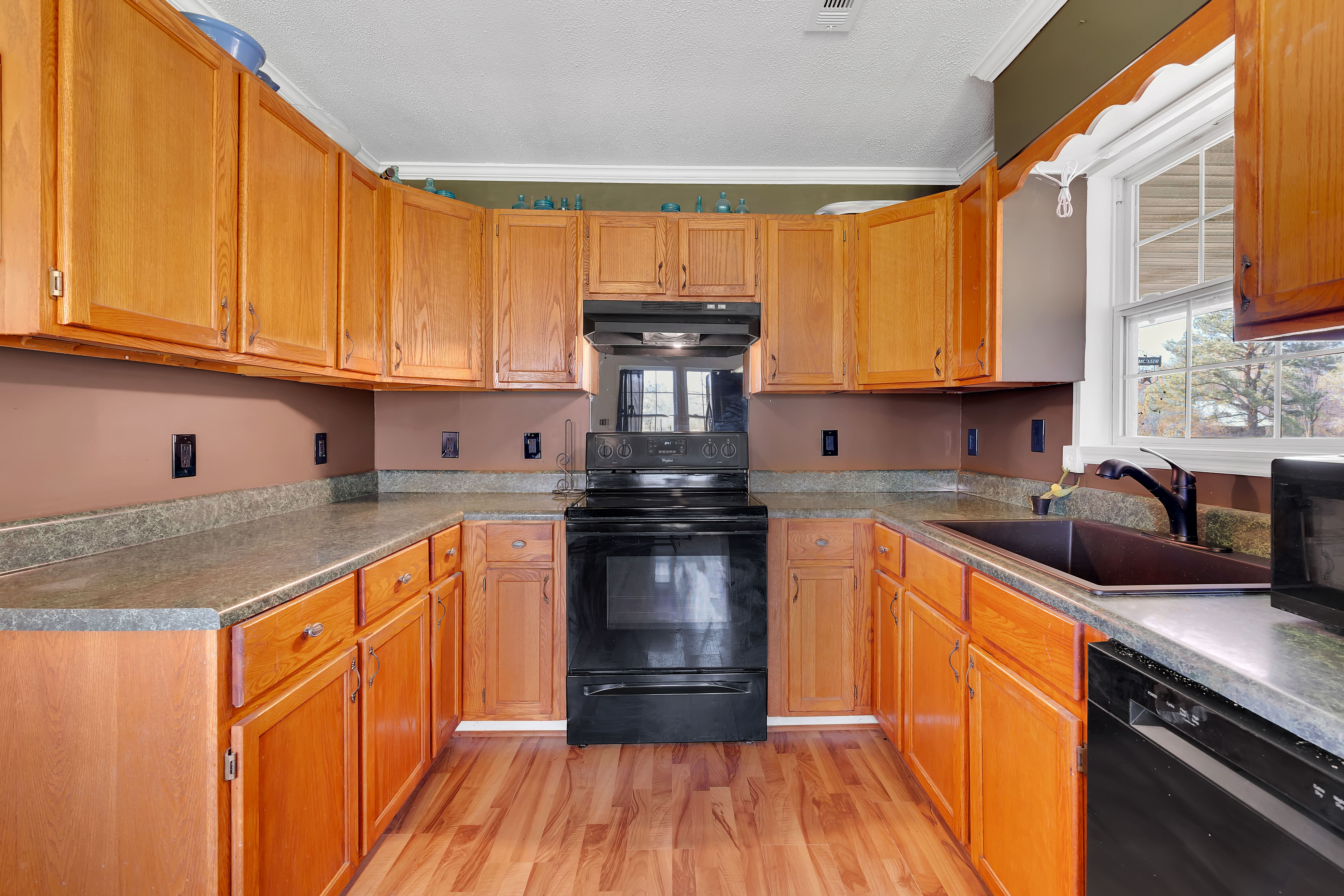 2073 Harpo Road Manchester, TN 37355 - Photo 31 of 45 a kitchen with stainless steel appliances granite countertop wooden cabinets a stove and a sink