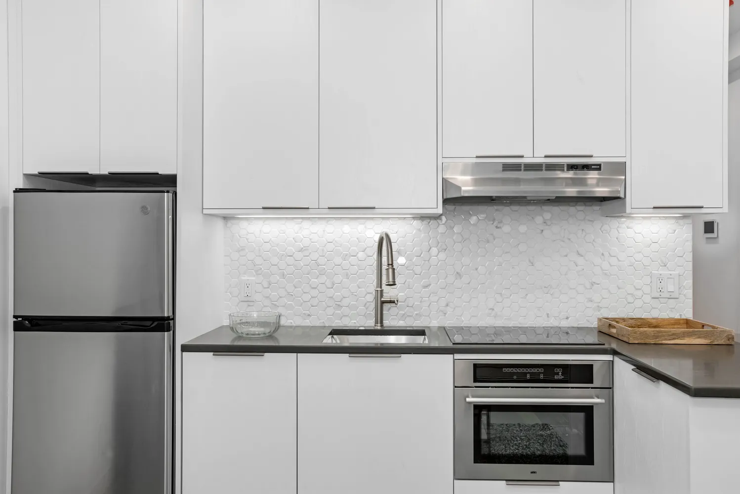 a kitchen with stainless steel appliances granite countertop a stove a refrigerator and a granite counter tops