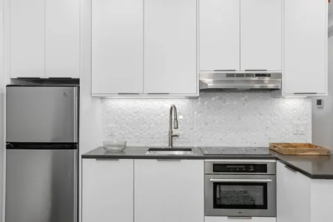 a kitchen with stainless steel appliances granite countertop a stove a refrigerator and a granite counter tops