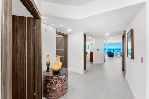 a view of a hallway with living room and furniture