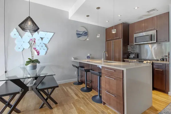 a kitchen with stainless steel appliances granite countertop a sink and a refrigerator