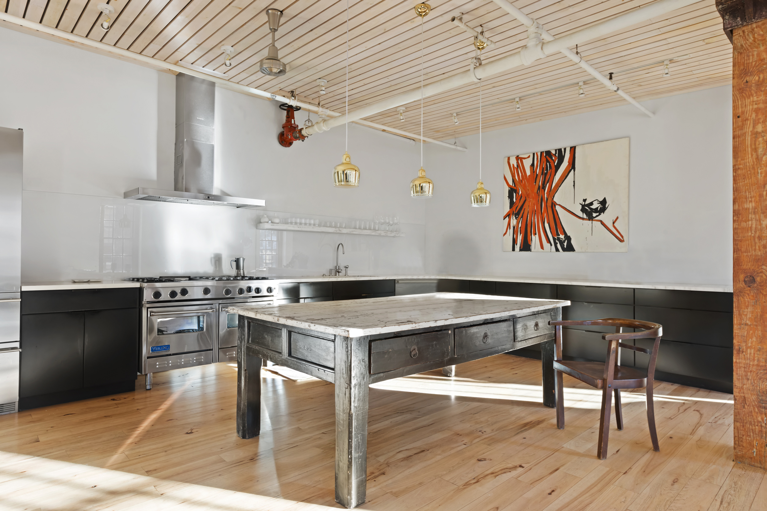 463 Greenwich Street Manhattan, NY 10013 - Photo 5 of 24 a kitchen with stainless steel appliances granite countertop a stove and a wooden floors