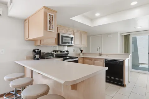 a kitchen with a sink a stove and cabinets