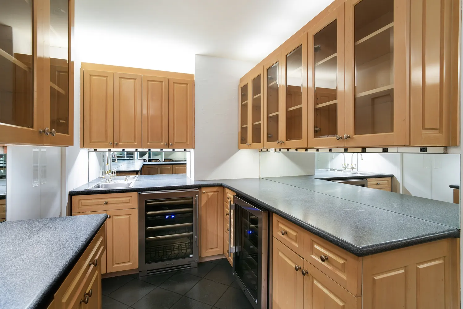a kitchen with kitchen island granite countertop a sink and a stove