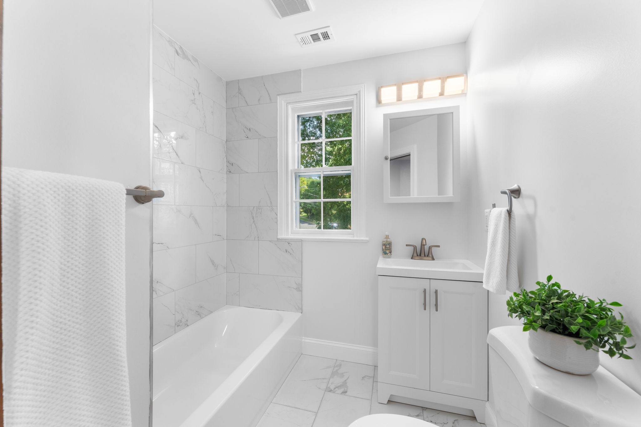 1325 Locust Road Northwest Washington, DC 20012 - Photo 38 of 56 a bathroom with a bathtub sink and mirror