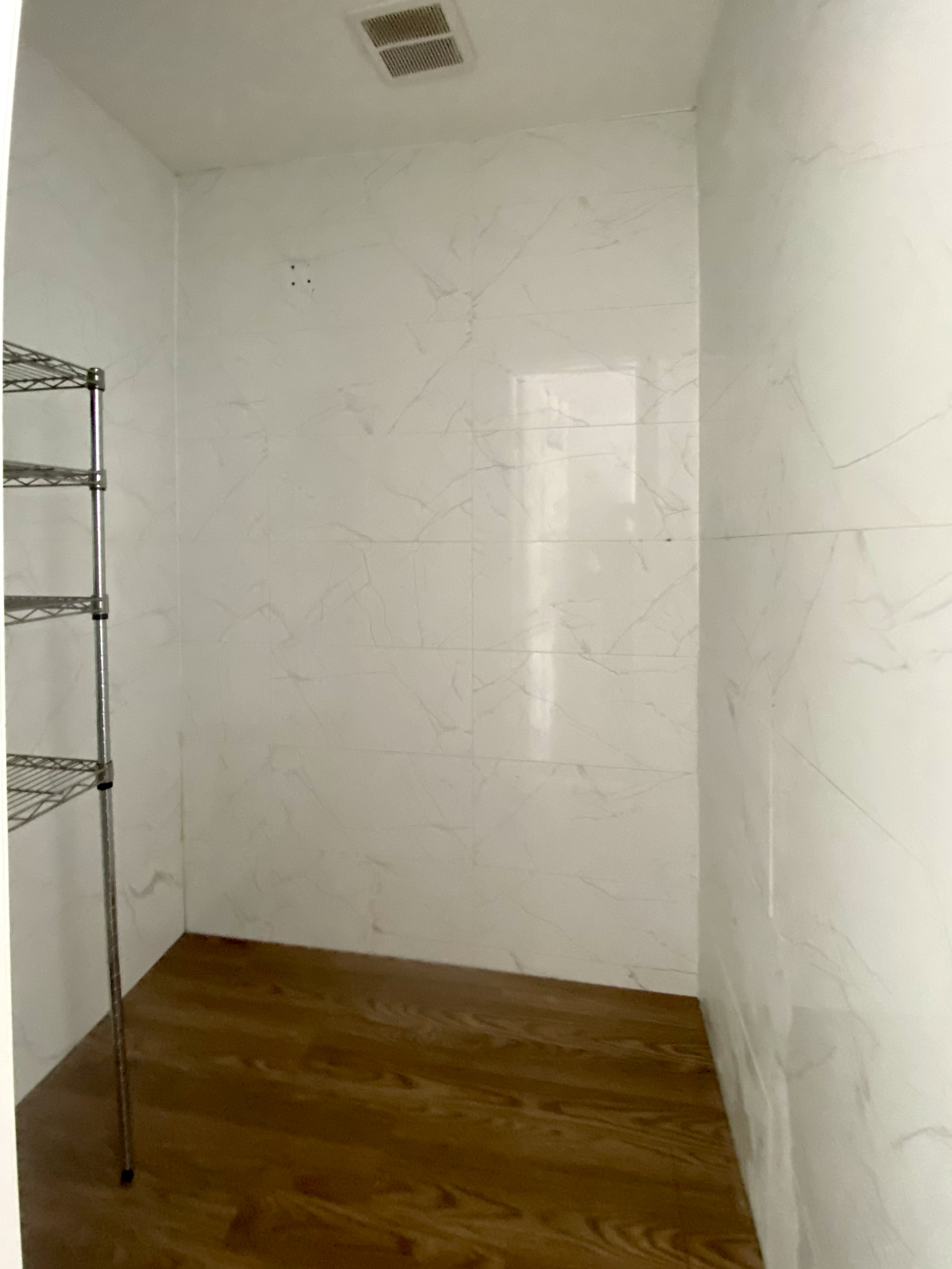 40 East Broadway, Unit 5 Manhattan, NY 10002 - Photo 8 of 10 a view of an empty room with wooden floor