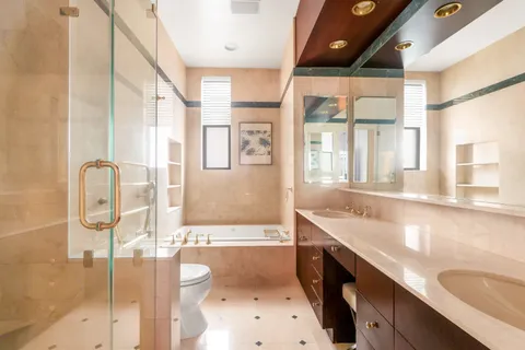 a spacious bathroom with a granite countertop sink and a large mirror