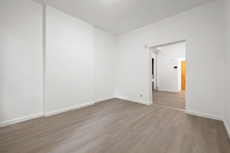312 West 49th Street, Unit 1RW Manhattan, NY 10019 - Photo 8 of 12 a view of an empty room with wooden floor