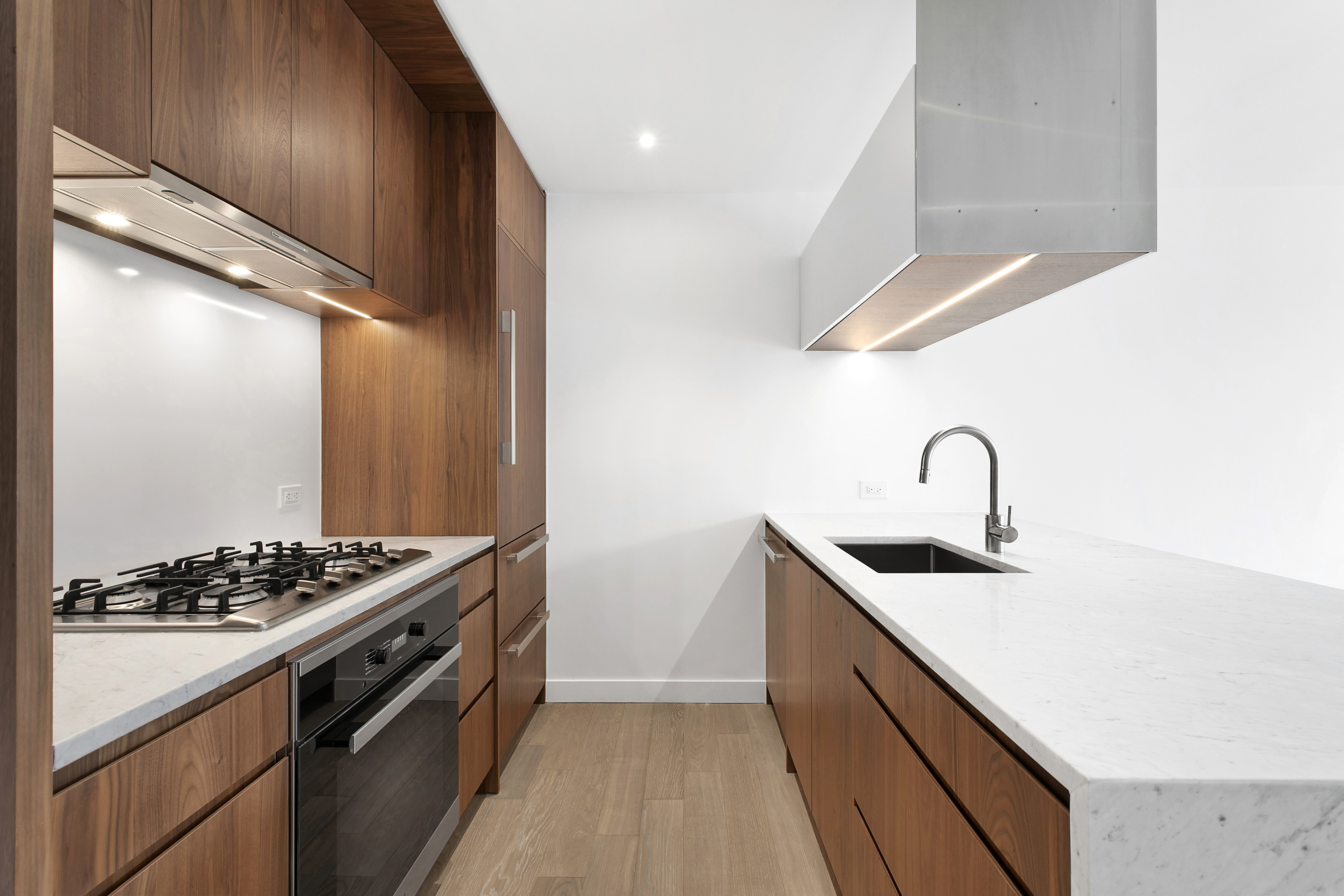 a kitchen with stainless steel appliances granite countertop a sink stove and cabinets