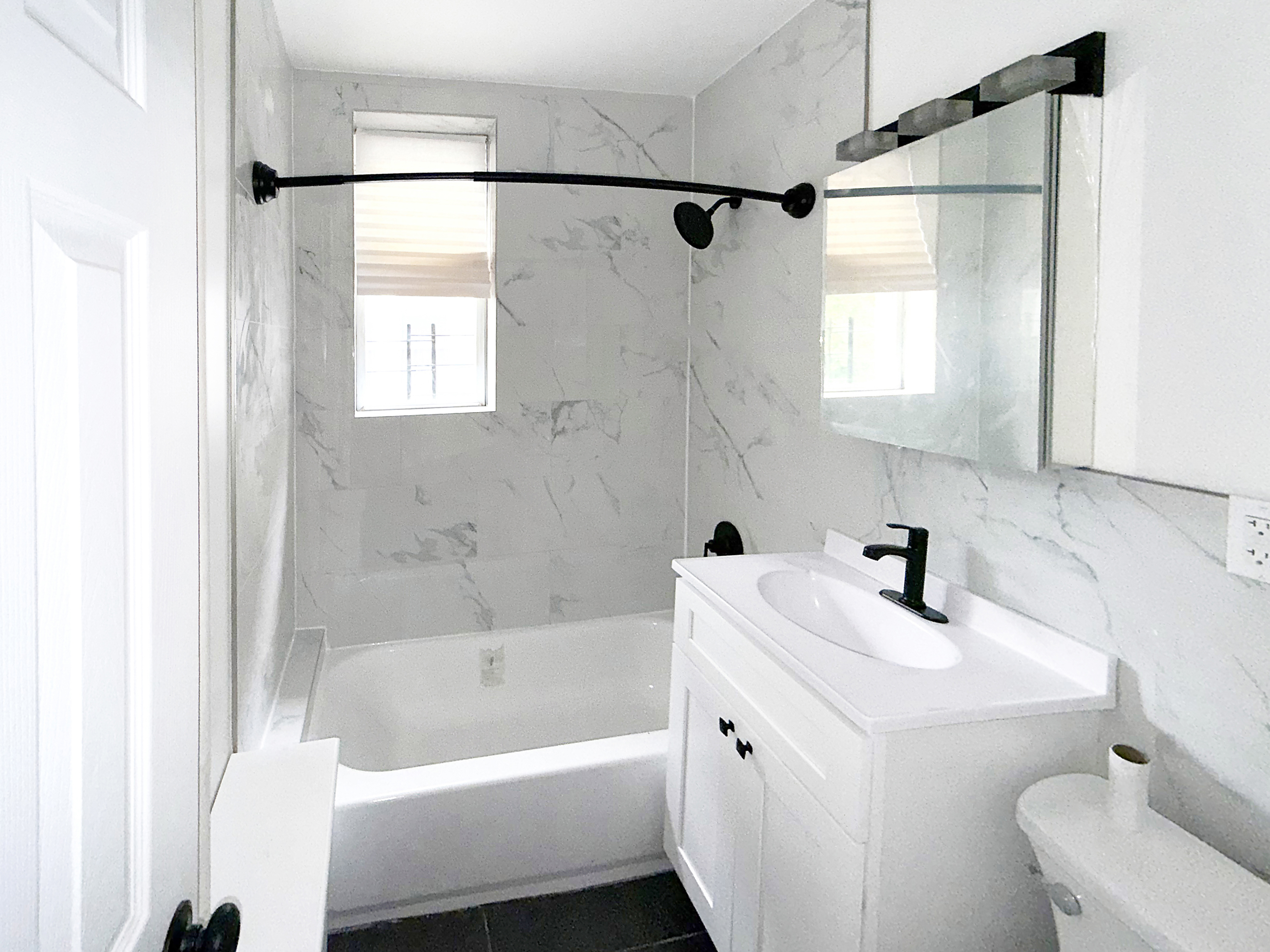 319 East 49th Street, Unit 1 Brooklyn, NY 11203 - Photo 8 of 8 a bathroom with a bathtub a sink a toilet and a shower