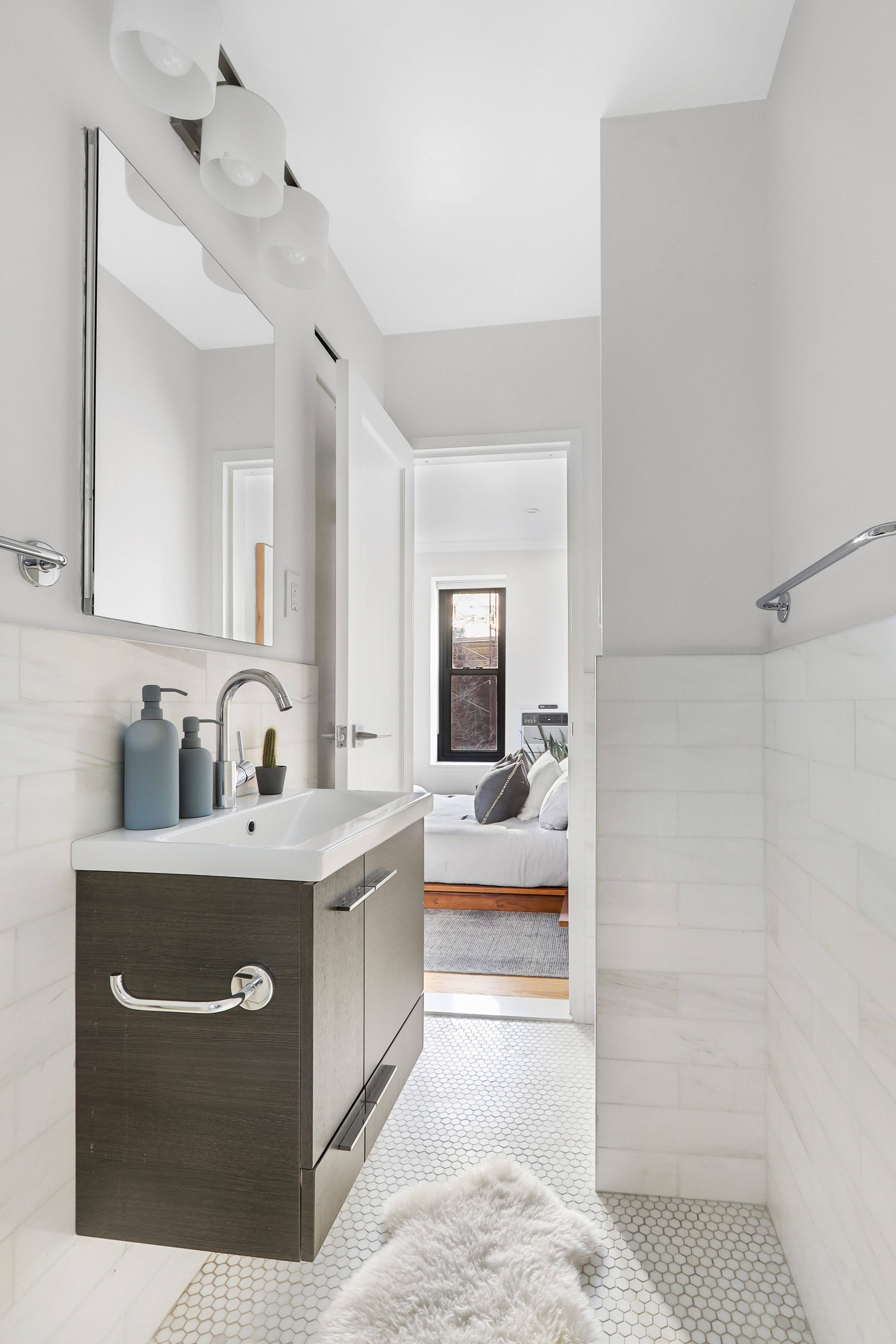 250 West 103rd Street, Unit 4A Manhattan, NY 10025 - Photo 9 of 14 a view of a bathroom with sink bathtub and mirror