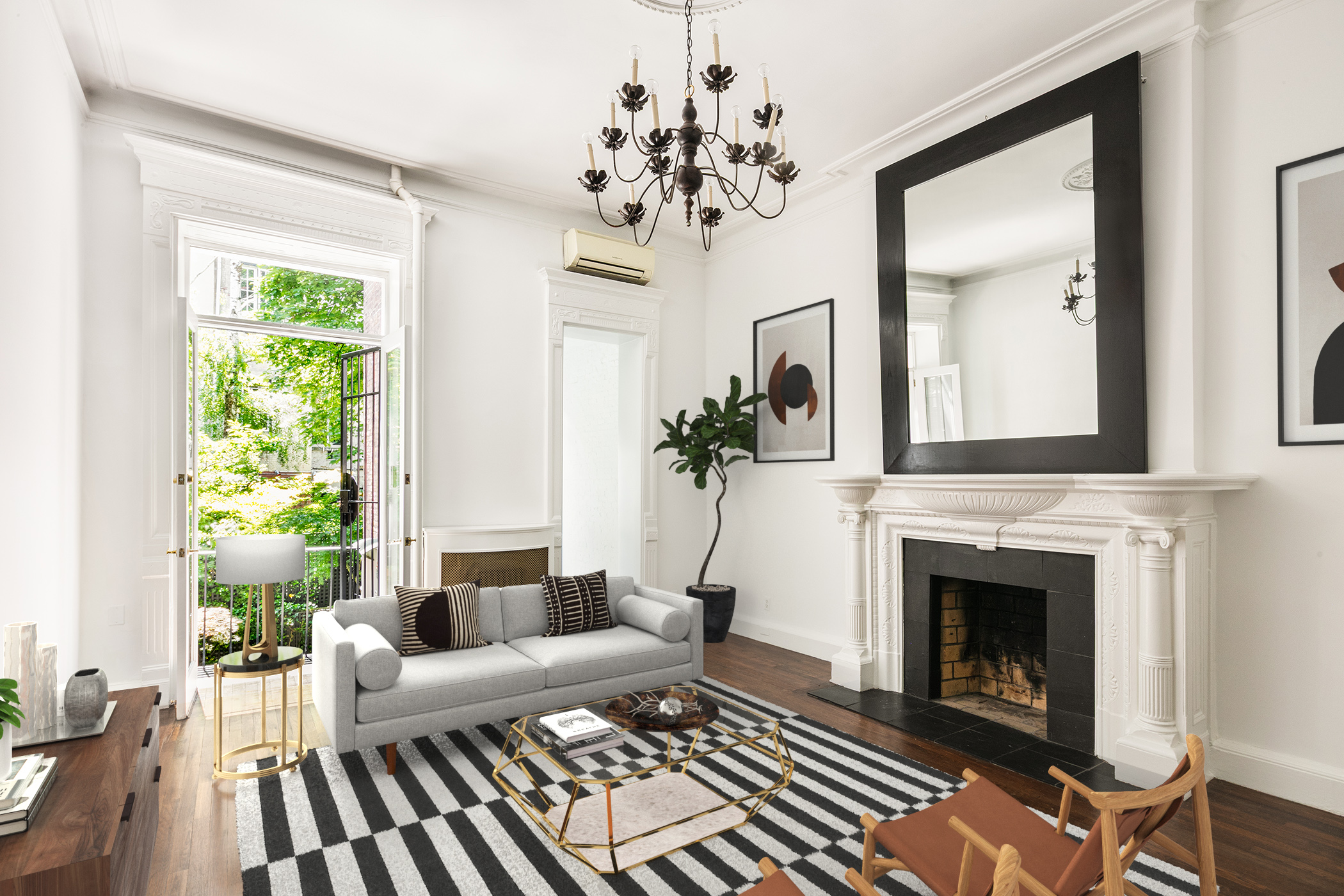 a living room with furniture a chandelier and a fireplace