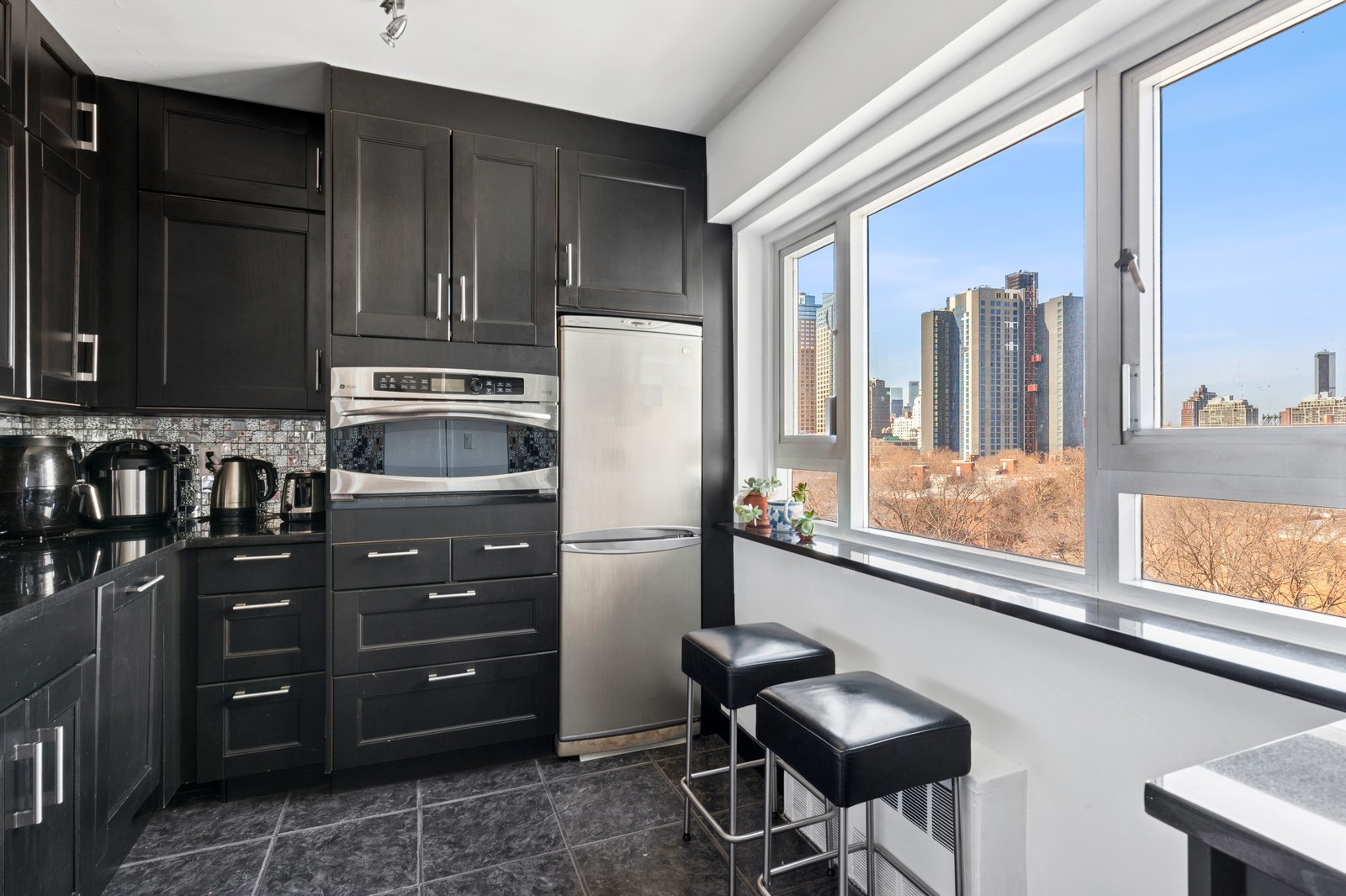 105 Ashland Place, Unit 10E Brooklyn, NY 11201 - Photo 4 of 7 a kitchen with stainless steel appliances granite countertop a refrigerator and a stove top oven