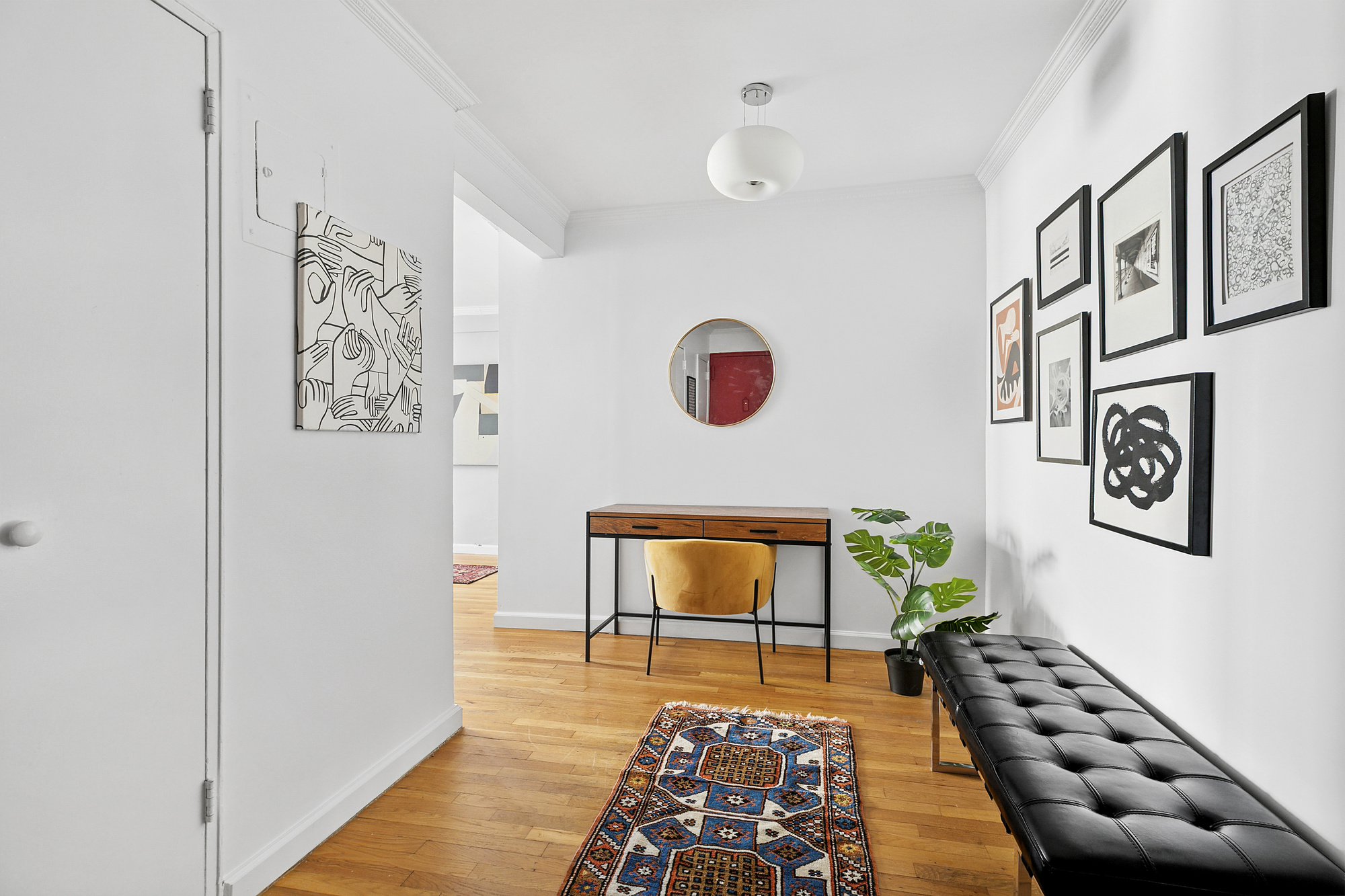 201 East 15th Street, Unit 7AJ Manhattan, NY 10003 - Photo 6 of 10 a hallway with wooden floor and white walls