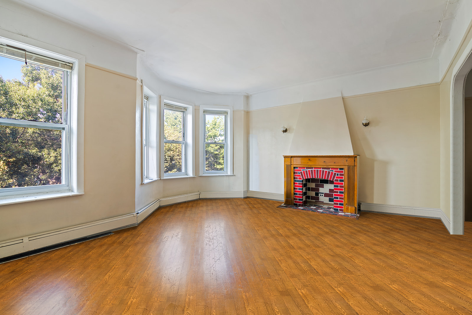 1168 Eastern Parkway Brooklyn, NY 11213 - Photo 2 of 9 a view of an empty room with a window and a fireplace