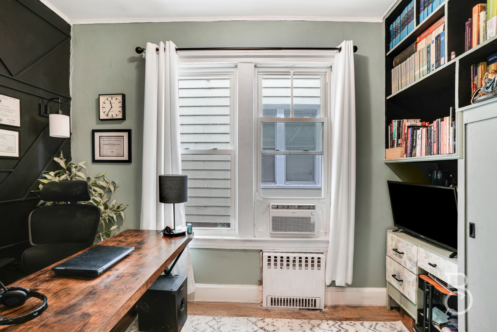 37-09 20th Road Queens, NY 11105 - Photo 12 of 16 a living room with furniture a flat screen tv and a fireplace