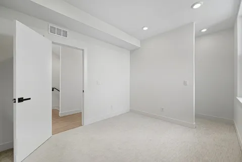 an empty room with an entryway and window
