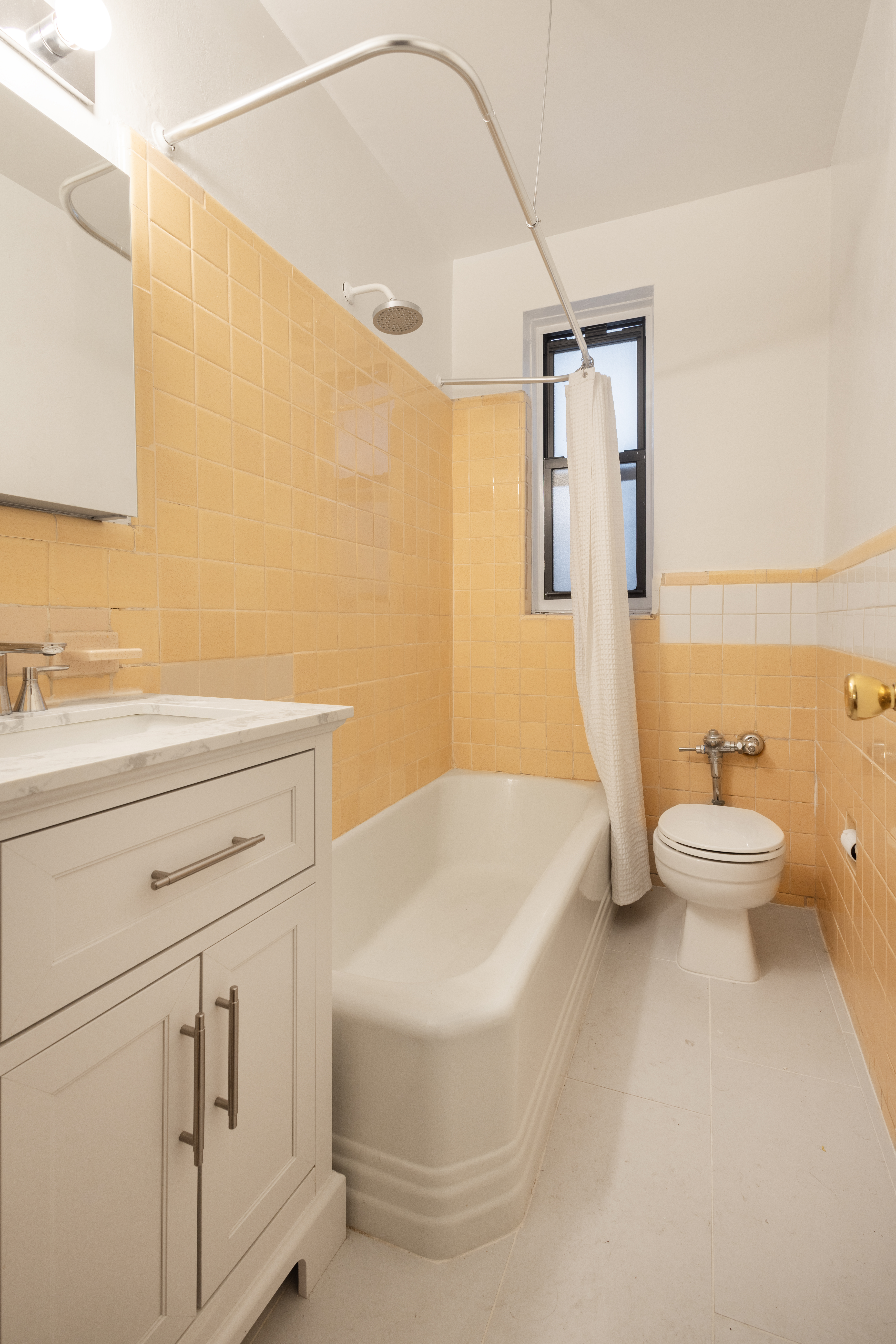 303 East 37th Street, Unit 3A Manhattan, NY 10016 - Photo 8 of 11 a bathroom with a sink a toilet and shower