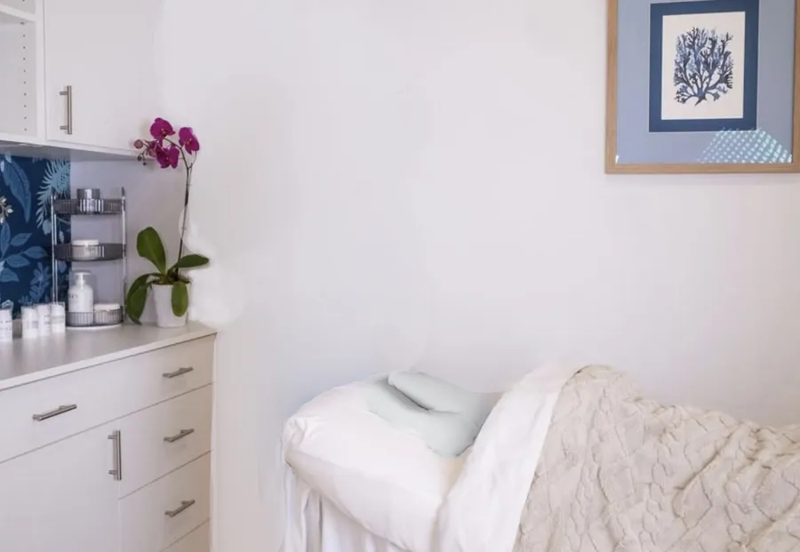 a bath room with a sink and a bed