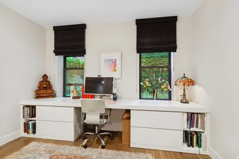 a workspace with furniture and a window