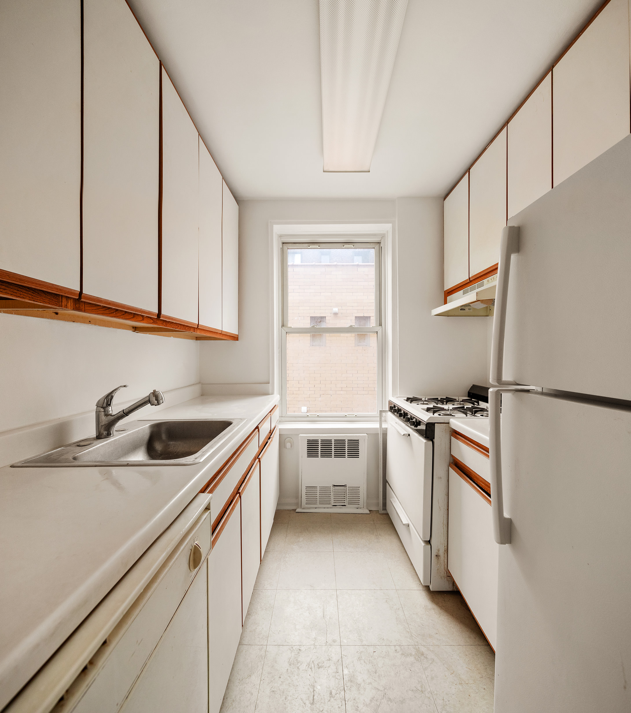1717 East 18th Street, Unit 4P Brooklyn, NY 11229 - Photo 2 of 8 a kitchen with a sink stove and refrigerator