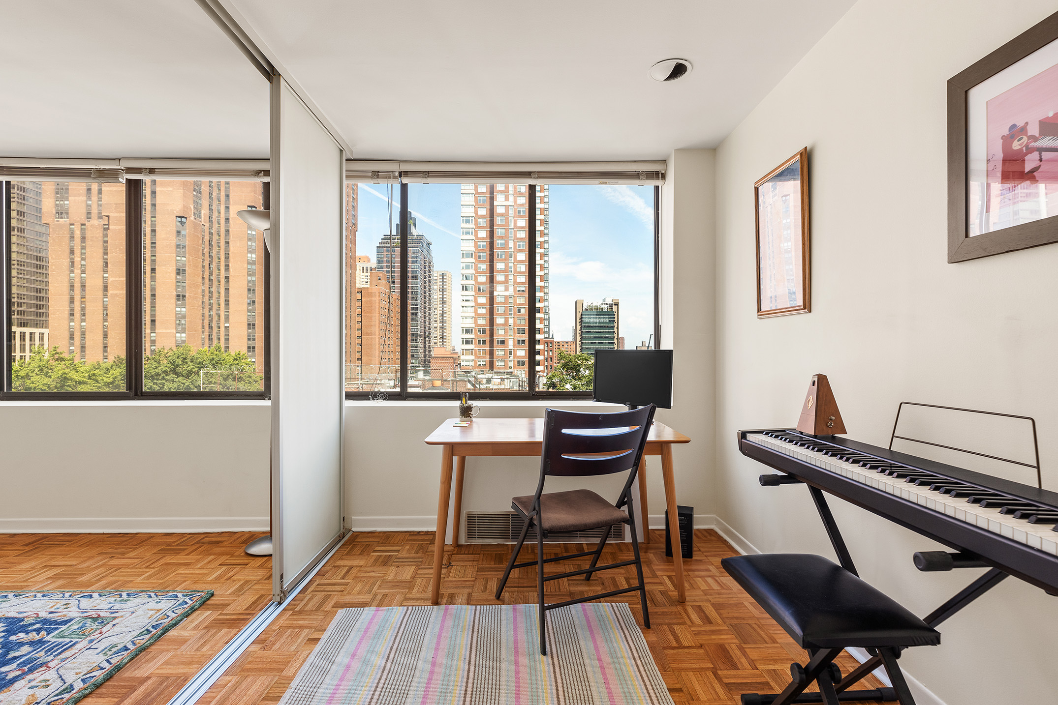300 East 90th Street, Unit 7C Manhattan, NY 10128 - Photo 7 of 12 a view of a workspace with furniture and a window