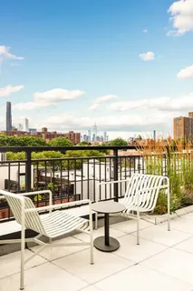 a view of swimming pool with outdoor seating and city view